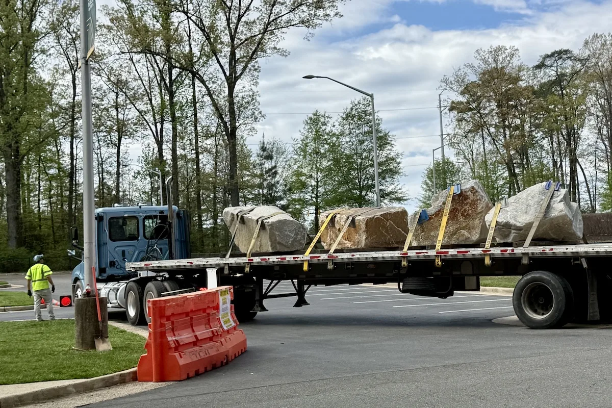 A truck transported 4 heavy builders to parking lot areas on Fairfax Campus