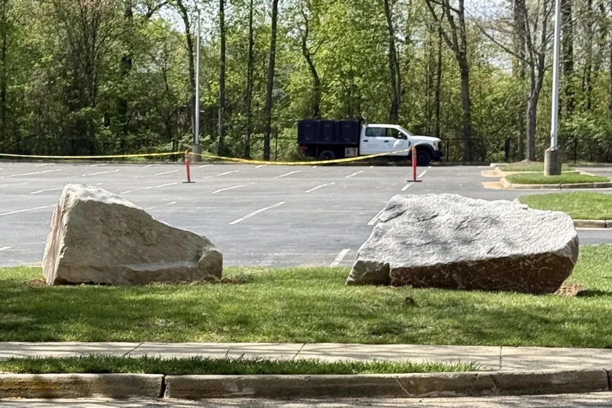 Builders are placed in the grass areas around parking lots to ensure proper traffic flow and safety during high traffic events.