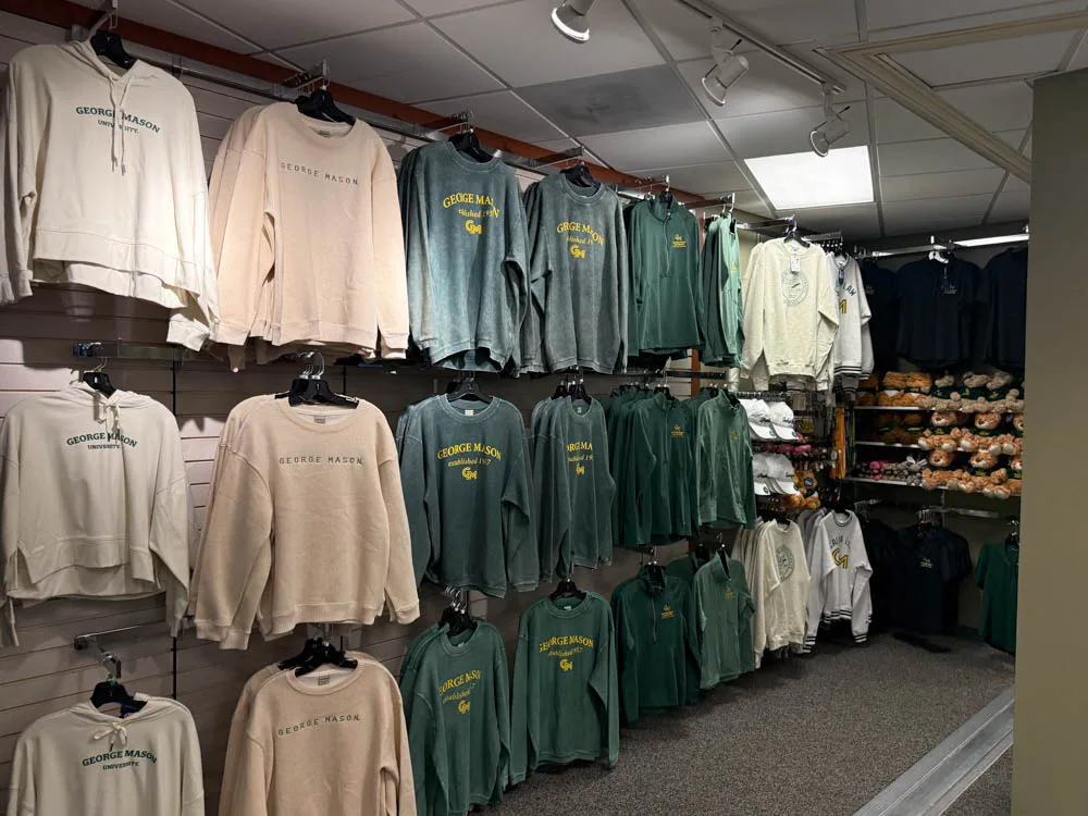 Mason Square Campus Store apparel wall features a variety of long sleeves, jerseys, hoodies