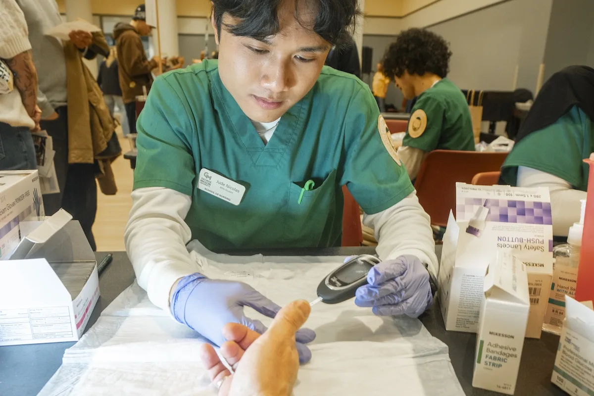 School of Nursing students check health screenings at the Health and Fitness Expo on the Fairfax Campus.