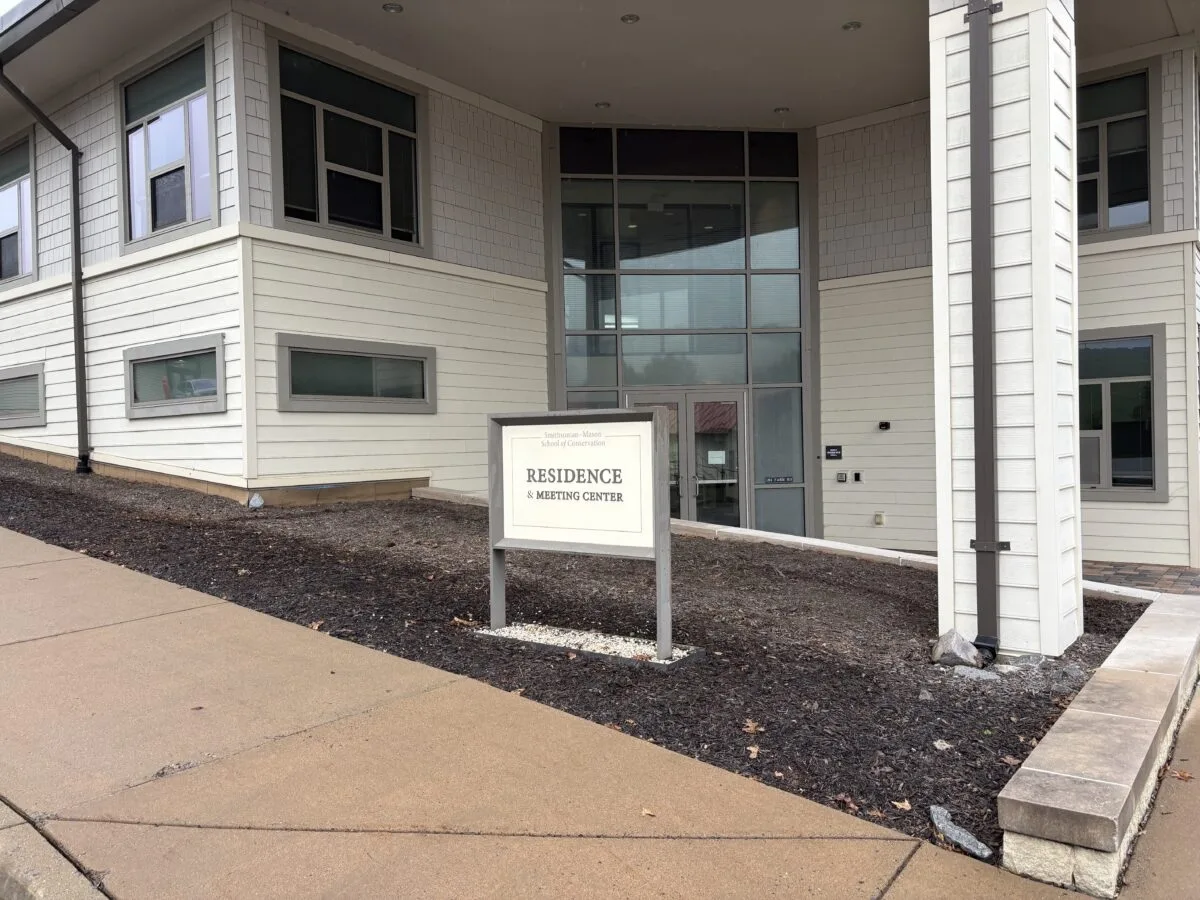A before photo of the ground space alongside of the residence hall.