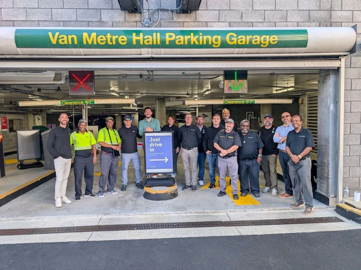Picture of Parking and Transportation staff members in front of the FUSE parking garage, the first garage piloting the AI-powered automated parking experience