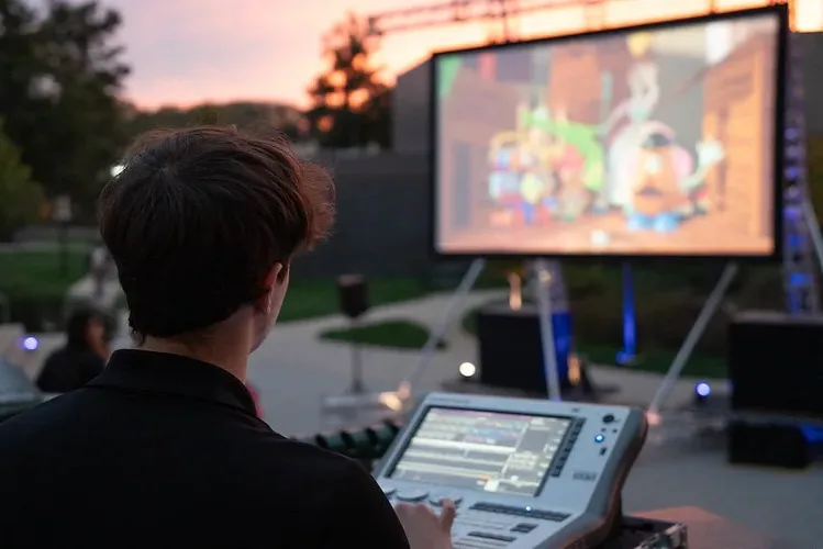 Event Services student staff members gained hands-on experience in daylight outdoor projection techniques, and real-time color uplight coordination to match film scenes.