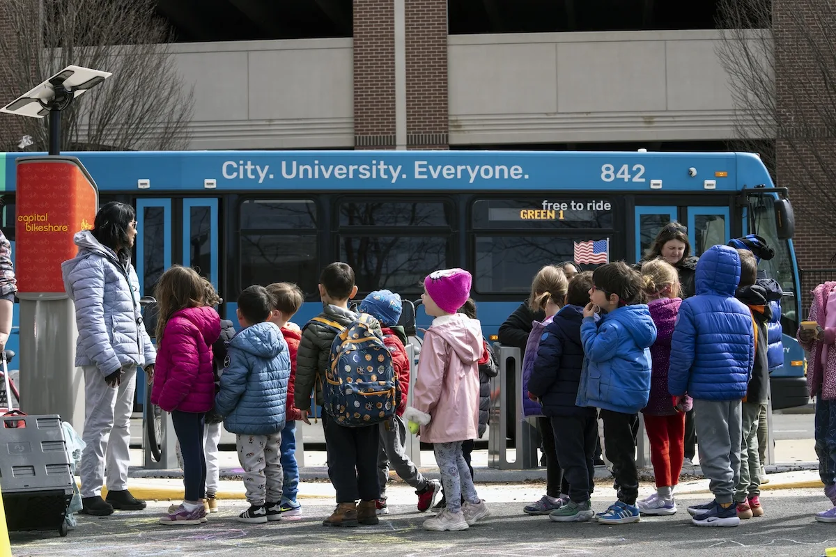 Children lined up waiting for their turn to give the gift bags to transit drivers.