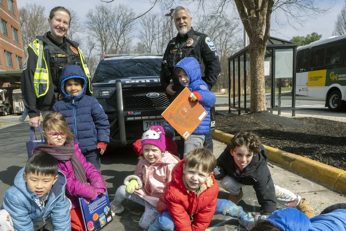 Children were chalking and coloring with Mason Police officers while waiting for buses' arrival
