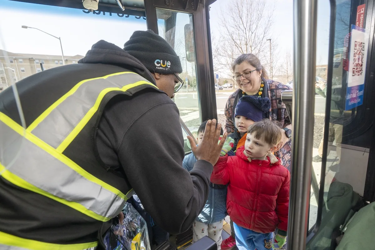 A child gave high five to a transit bus driver after delivering a goodie bag
