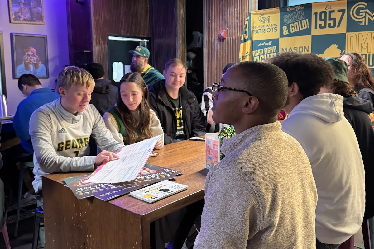Current George Mason students gathered around.